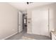 Neutral bedroom featuring carpeted floors, an open doorway, and a closet with sliding doors at 5114 E Hartford Ave, Scottsdale, AZ 85254