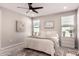 Bright bedroom with neutral decor, plush bedding, ceiling fan, and large area rug at 5114 E Hartford Ave, Scottsdale, AZ 85254