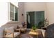 A serene patio featuring modern outdoor seating, a sliding glass door, and a potted plant at 5114 E Hartford Ave, Scottsdale, AZ 85254