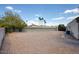 Large, low-maintenance backyard with gravel landscaping and mature trees offering shade at 536 W Surrey Ave, Phoenix, AZ 85029