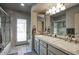 Elegant bathroom with double sinks, granite countertops, and a glass-enclosed shower at 536 W Surrey Ave, Phoenix, AZ 85029