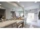 Modern bathroom featuring double sinks, granite countertop and a walk-in shower at 536 W Surrey Ave, Phoenix, AZ 85029