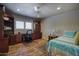 Cozy bedroom with a ceiling fan, built-in desk, and ample closet space at 536 W Surrey Ave, Phoenix, AZ 85029