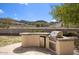 Outdoor kitchen featuring a stainless steel grill and mini fridge, ideal for outdoor cooking and entertaining at 536 W Surrey Ave, Phoenix, AZ 85029
