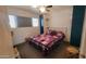 Cozy bedroom with ceiling fan, featuring a colorful quilt, and ample natural light at 5429 N Black Cyn Hwy, Phoenix, AZ 85015