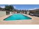 Sparkling community pool with lounge chairs and umbrellas for relaxation at 5429 N Black Cyn Hwy, Phoenix, AZ 85015