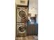 Convenient laundry area featuring a stacked washer and dryer, with a peek into the kitchen at 5429 N Black Cyn Hwy, Phoenix, AZ 85015