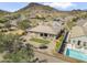Aerial view of backyard featuring artificial turf and a covered patio in a desert landscape at 5721 W Molly Ln, Phoenix, AZ 85083