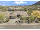An aerial view of a home showcasing its desert landscaping, a driveway and mountain views at 5721 W Molly Ln, Phoenix, AZ 85083