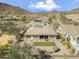 Aerial view of backyard with artificial turf and a covered patio in a neighborhood near mountains at 5721 W Molly Ln, Phoenix, AZ 85083
