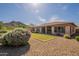 Well-maintained backyard with artificial turf putting green, desert landscaping, and mountain backdrop at 5721 W Molly Ln, Phoenix, AZ 85083