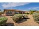 Spacious backyard featuring desert landscaping, mature bushes and a covered patio at 5721 W Molly Ln, Phoenix, AZ 85083
