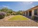 Beautiful backyard with a grass putting range and desert landscaping in the distance at 5721 W Molly Ln, Phoenix, AZ 85083