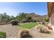 Landscaped backyard with artificial turf lawn, patio, and scenic mountain views in a tranquil setting at 5721 W Molly Ln, Phoenix, AZ 85083
