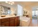 Bright bathroom featuring a soaking tub, tiled cabinets, and dual mirrors and sinks at 5721 W Molly Ln, Phoenix, AZ 85083