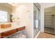 Bright bathroom featuring a vanity area with a shower and a view into an organized walk-in closet at 5721 W Molly Ln, Phoenix, AZ 85083