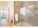 Bright bathroom featuring a glass shower, tiled walls and a glimpse into the main bedroom at 5721 W Molly Ln, Phoenix, AZ 85083