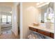 Bright bathroom featuring a vanity with an organized walk-in closet and access to the main bedroom at 5721 W Molly Ln, Phoenix, AZ 85083