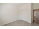 Light-filled bedroom with light grey vinyl floors, white walls, and double door closet at 5721 W Molly Ln, Phoenix, AZ 85083