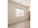 Bedroom featuring light grey vinyl floors, white walls, and a window with blinds at 5721 W Molly Ln, Phoenix, AZ 85083
