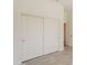 Spacious bedroom featuring a double door closet, light grey vinyl floors, and white walls at 5721 W Molly Ln, Phoenix, AZ 85083