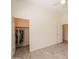 Bright bedroom with grey vinyl floors, white walls, and closet at 5721 W Molly Ln, Phoenix, AZ 85083