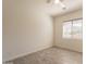 Bright bedroom featuring light grey vinyl floors, white walls, and a window with blinds at 5721 W Molly Ln, Phoenix, AZ 85083
