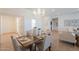 Open concept dining room with a chandelier, tile floors and light-filled spaces at 5721 W Molly Ln, Phoenix, AZ 85083