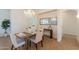 Dining room with white chairs, a modern chandelier, and bright, neutral decor at 5721 W Molly Ln, Phoenix, AZ 85083