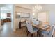 Bright dining room featuring a chandelier, mirror, and stylish furnishings at 5721 W Molly Ln, Phoenix, AZ 85083