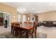 Open dining area featuring wood table and decorative chandelier, seamlessly connected to the living space at 5721 W Molly Ln, Phoenix, AZ 85083
