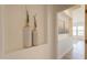 Tastefully decorated hallway with recessed art niche with decorative vases and view to living area at 5721 W Molly Ln, Phoenix, AZ 85083