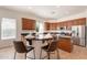 Eat-in kitchen with a rounded breakfast bar, stainless appliances, and dark wood cabinets at 5721 W Molly Ln, Phoenix, AZ 85083