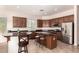 Kitchen featuring dark wood cabinets, stainless steel appliances, and granite countertops with breakfast bar seating at 5721 W Molly Ln, Phoenix, AZ 85083