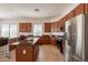 Modern kitchen with stainless steel appliances, dark cabinets, and a center island at 5721 W Molly Ln, Phoenix, AZ 85083