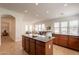 Open-concept kitchen boasts dark granite countertops, tile flooring, and an eat-in island with breakfast bar at 5721 W Molly Ln, Phoenix, AZ 85083