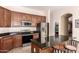Kitchen with dark cabinets, stainless steel appliances and granite countertops, offering a blend of style and functionality at 5721 W Molly Ln, Phoenix, AZ 85083