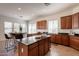Spacious kitchen featuring dark cabinets, black countertops and a breakfast bar at 5721 W Molly Ln, Phoenix, AZ 85083