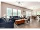 Bright and airy living room flows into dining space with large windows, comfortable seating, and a decorative fireplace at 5721 W Molly Ln, Phoenix, AZ 85083
