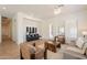 Bright and open living room features neutral colors, tile flooring, and a stylish entertainment center at 5721 W Molly Ln, Phoenix, AZ 85083