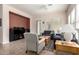The living room includes a comfortable sitting arrangement, large windows and a television at 5721 W Molly Ln, Phoenix, AZ 85083