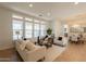 Inviting living room with neutral furniture, large windows, and seamless open-concept design to dining area at 5721 W Molly Ln, Phoenix, AZ 85083