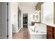 Bright main bathroom featuring a separate tub and shower, and updated fixtures at 5721 W Molly Ln, Phoenix, AZ 85083