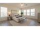 Spacious main bedroom featuring light grey vinyl floors, a ceiling fan, and an area rug at 5721 W Molly Ln, Phoenix, AZ 85083