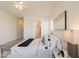 Bright main bedroom featuring neutral walls, ceiling fan, and a soft, inviting bed with decorative pillows at 5721 W Molly Ln, Phoenix, AZ 85083