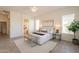 Bright main bedroom with an ensuite bathroom and light grey vinyl flooring at 5721 W Molly Ln, Phoenix, AZ 85083
