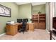 Spacious home office equipped with a desk, bookcase, and neutral green walls at 5721 W Molly Ln, Phoenix, AZ 85083
