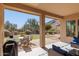 Covered patio includes an outdoor dining area, seating, and views of landscaped backyard and mountains at 5721 W Molly Ln, Phoenix, AZ 85083