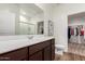 Bright bathroom with a vanity, mirror, and tile flooring at 5875 N 195Th Dr, Litchfield Park, AZ 85340