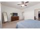 Bedroom view with wood dresser, mirror, carpeted floor, and ceiling fan at 5875 N 195Th Dr, Litchfield Park, AZ 85340